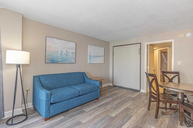 Interior space featuring baseboards, a textured ce