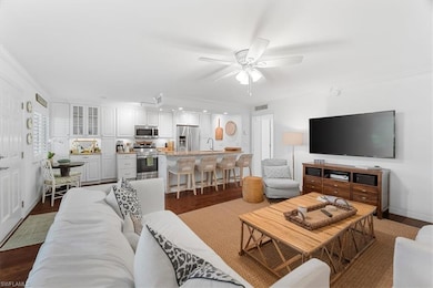Living room with dark wood-style flooring, ceiling