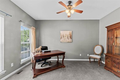 Home office has french doors and ceiling fan!