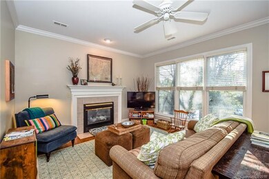 Great Room with fireplace and view of the backyard