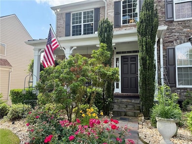View of exterior entry featuring brick siding and covered porch