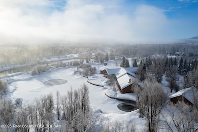 Aerial View of Property with Pond
