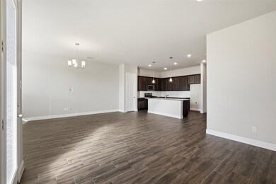 Unfurnished living room featuring recessed lighting, a chandelier, and dark wood-style flooring