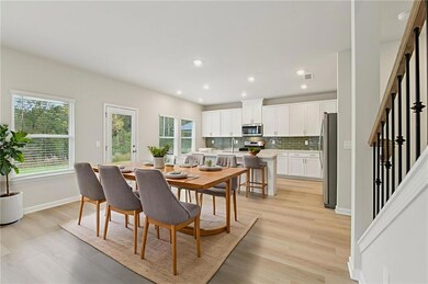 Dining area with healthy amount of natural light, light wood-style flooring, recessed lighting, and stairs