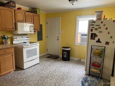 Kitchen featuring crown molding, white appliances,