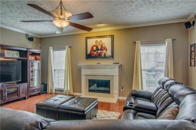 Cozy living area with a wood burning fireplace tha