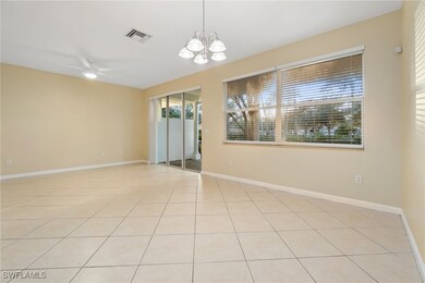 Empty room featuring light tile patterned floors, a chandelier, and ceiling fan