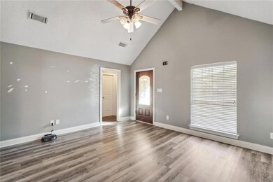 Living room w/ cathedral ceilings