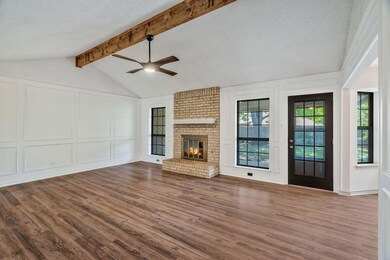 Unfurnished living room with lofted ceiling with b