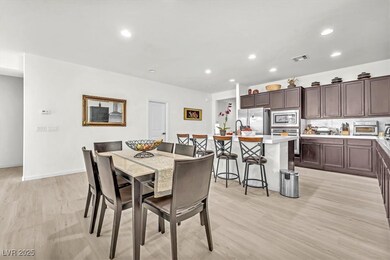 Dining room with recessed lighting and light wood-type flooring