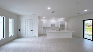 Kitchen featuring white cabinets, sink, and a kitc