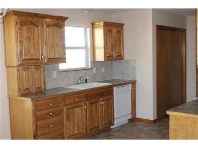 lots of cabinets, tile backsplash, laundry closet