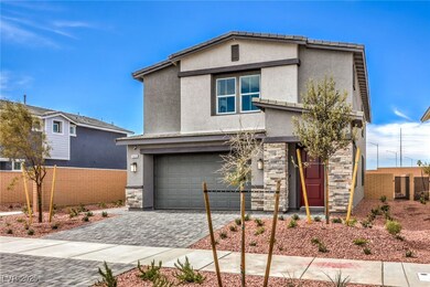 Photo is representational only; actual home finishes may vary. View of front of home featuring stone siding, stucco siding, an attached garage, and decorative driveway