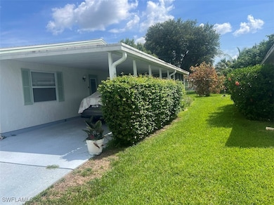 View of property exterior with a lawn, an attached