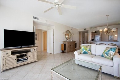 Tiled living room featuring ceiling fan with notab