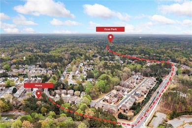 Aerial overview of property's location featuring a heavily wooded area and property boundaries highlighted