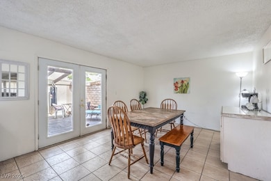 Dining space with light tile patterned flooring, f
