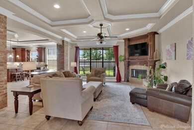 Living room with ornamental molding, a large firep