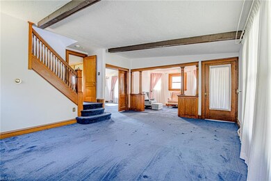 A separate space to your right inside the living room could be an office, library or den