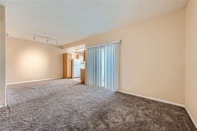 Unfurnished room with light carpet, baseboards, an