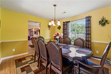 Living area featuring light wood finished floors, ceiling fan, a textured ceiling, and a baseboard heating unit