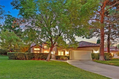 View of front of house featuring a tiled roof, a g
