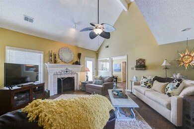 A cozy gas log fireplace highlights the family-siz