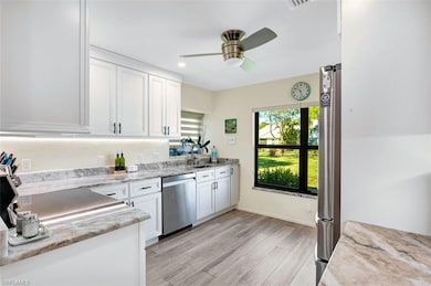Kitchen with light wood finished floors, a sink, c