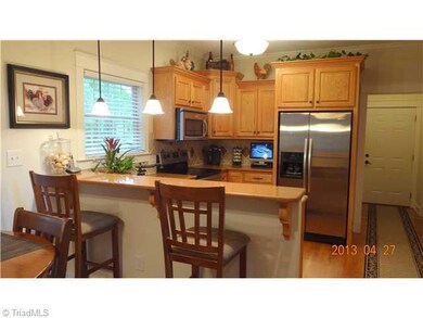 Kitchen. Custom kitchen with hardwood flooring, pantry, eat at bar & stainless steel appliances
