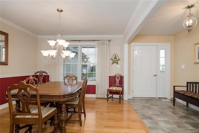 Foyer and formal dining room with crown molding, c