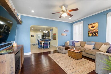 Living room has recessed lighting and engineered f