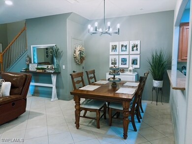 Dining space with a chandelier, stairs, and light