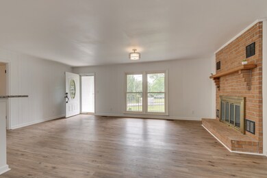 21x21 Living Room has a brick mantel and wood burning fireplace!