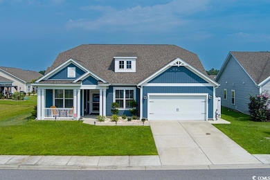 View of front facade with a front yard, a porch, and concrete driveway
