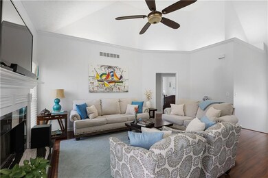 Living room with high vaulted ceiling, a ceiling f