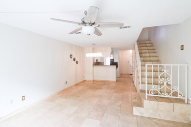 Unfurnished living room with stairway, a ceiling f