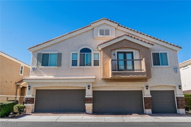 View of front of property featuring a garage, a ti