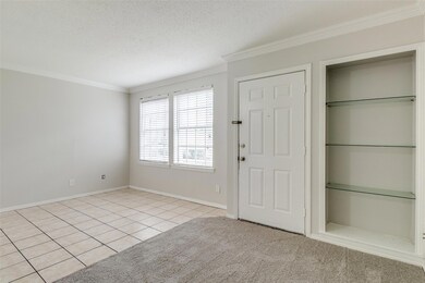 Entryway featuring crown molding, light tile patte