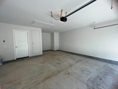 Garage with a garage door opener and baseboards