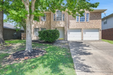 This is a two-story brick home with a double garag