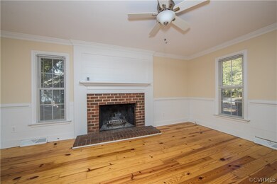 living room with wood floors, overhead fan, firepl