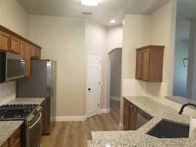 Kitchen with stainless steel appliances, a sink, 