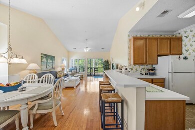 Kitchen with lofted ceiling, hanging light fixture