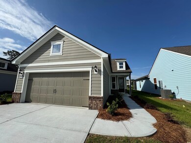 View of front of property with brick siding, concrete driveway, and central AC unit