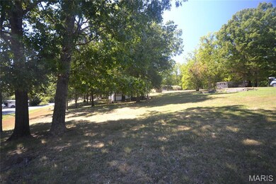 View of green lawn with view of wooded area