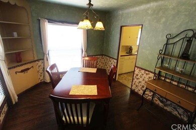 Formal Dining Room (or Den) with Built-In Hutch has beautiful views of Garden .