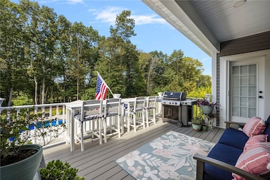 Composite deck off of the kitchen overlooks the backyard