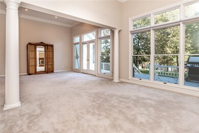 View of living room, deck, and back yard from the dining room.  House if full of natural light!