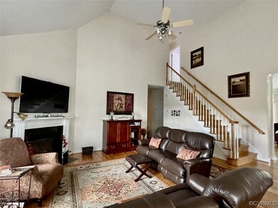 Hardwood floored living room featuring a high ceil