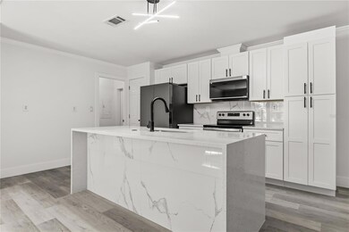 modern kitchen featuring brand-new appliances, new cabinets, new countertops, and stylish black fixtures.